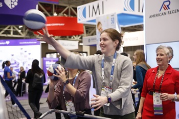 attendee playing a game in the exhibit hall